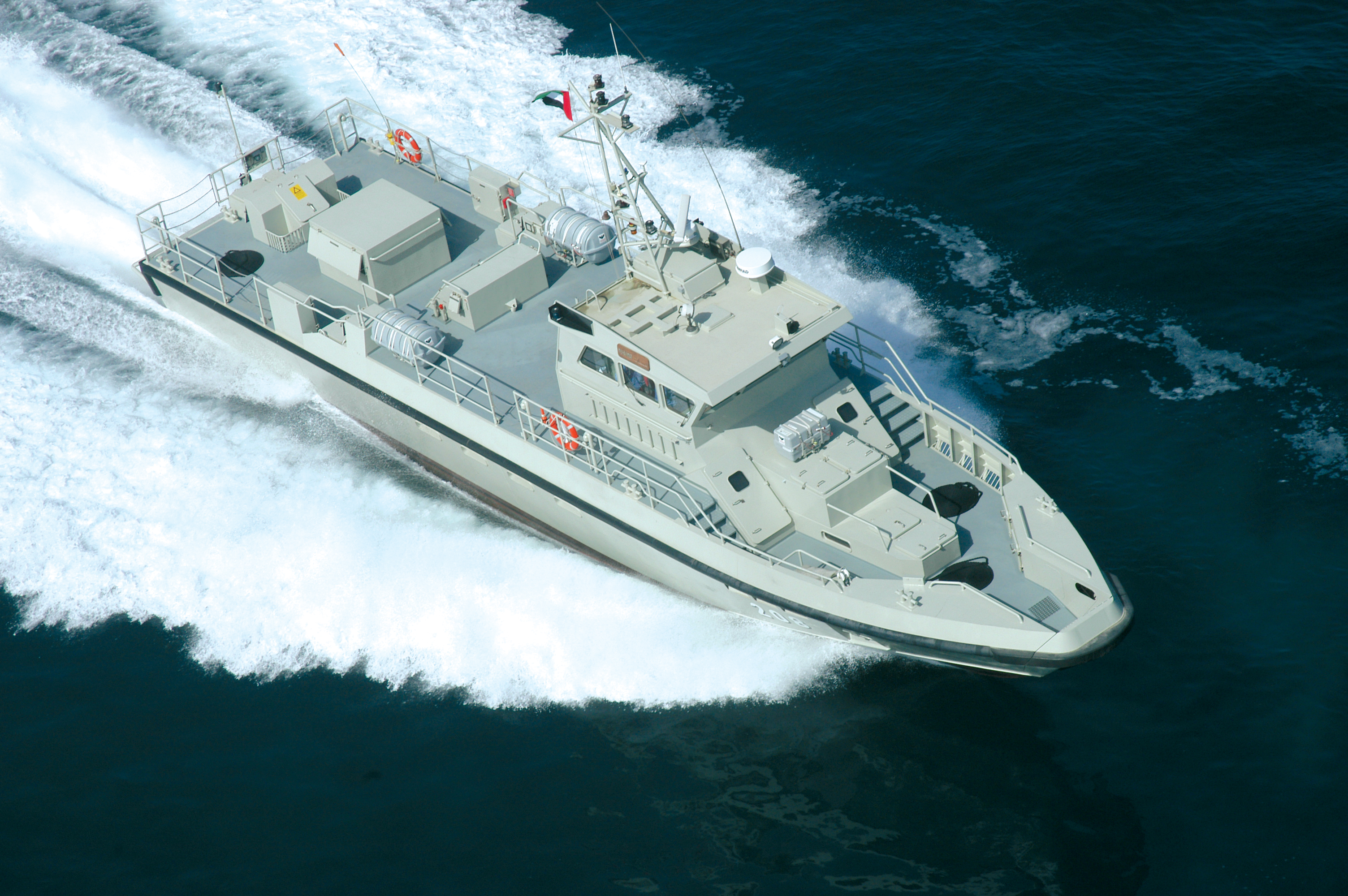 An aerial photo shows a high speed vessel underway in calm seas