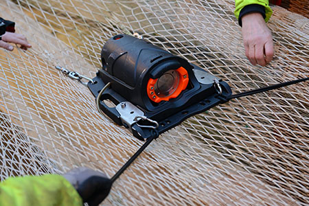 An acoustic tool attached to a fishing net.