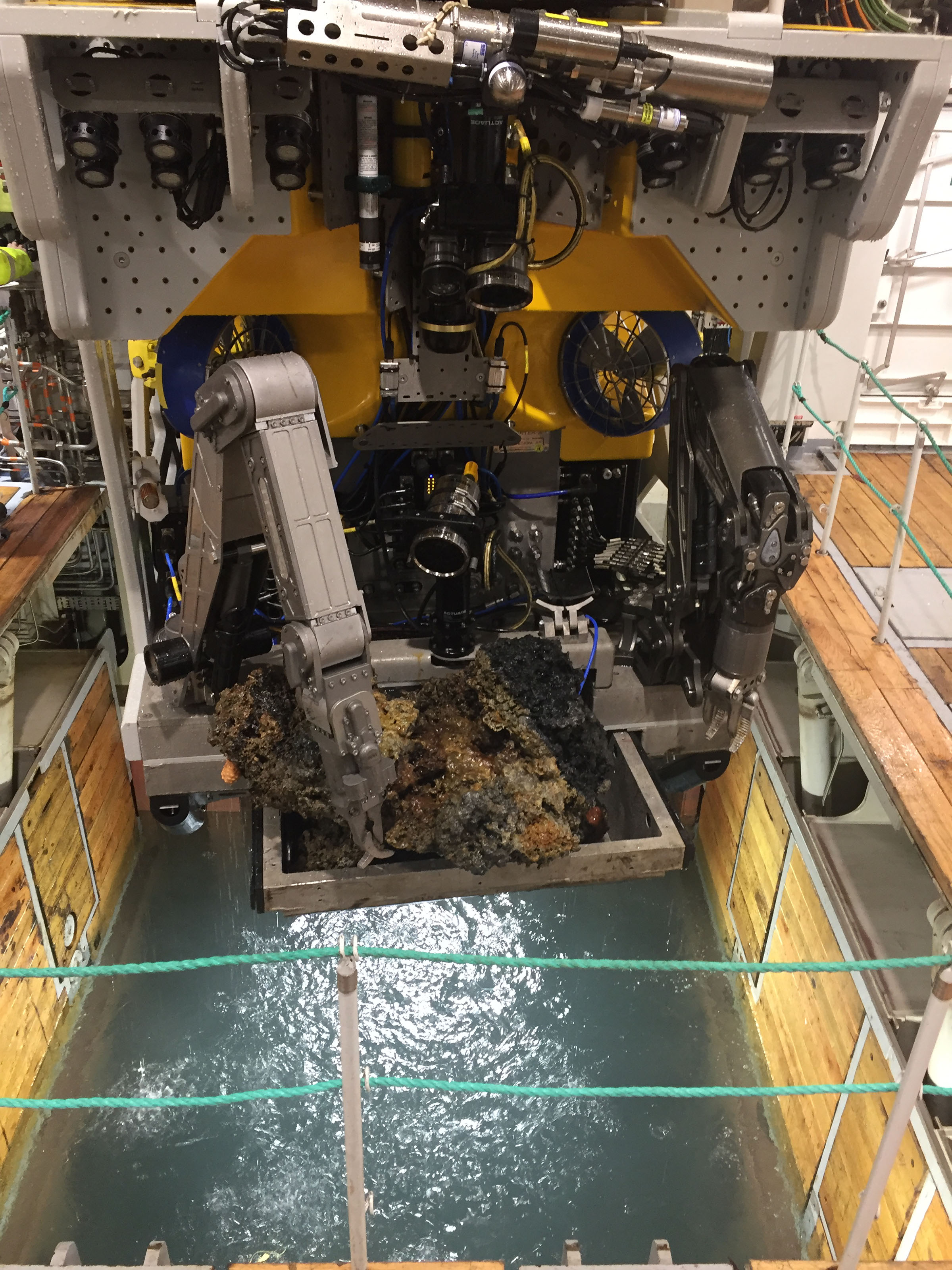 The ROV hanging over the moonpool whilst handling a sample collected from the seabed.