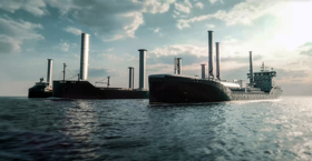 Large vessel at sea fitted with multiple vertical wind-assisted propulsion sails, viewed from the water under a cloudy sky.