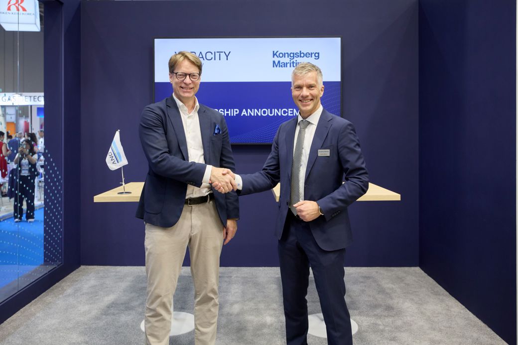 Mikkel Skou, Executive Director, Veracity by DNV  Anders Bryhni, Senior Vice President Digital, KM shaking hands  after signing an agreement on standardized Operational Vessel Data exchange.