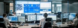 24/7 support centre with operators handling customer calls and monitoring marine systems across multiple screens