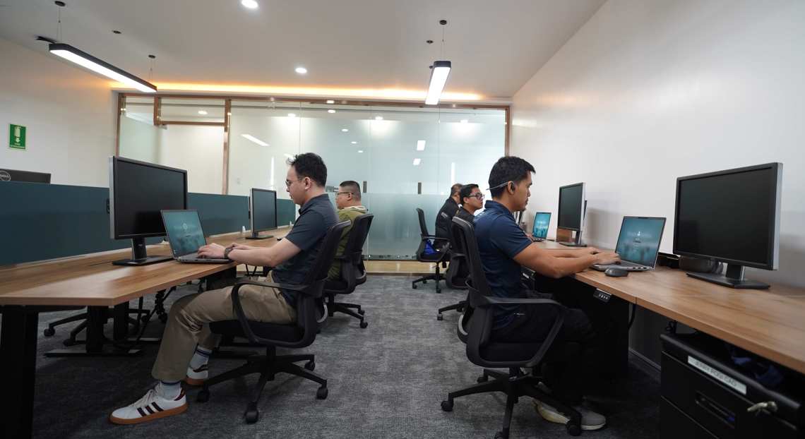 Employees working at desks in the new Kongsberg Maritime office in Manila.