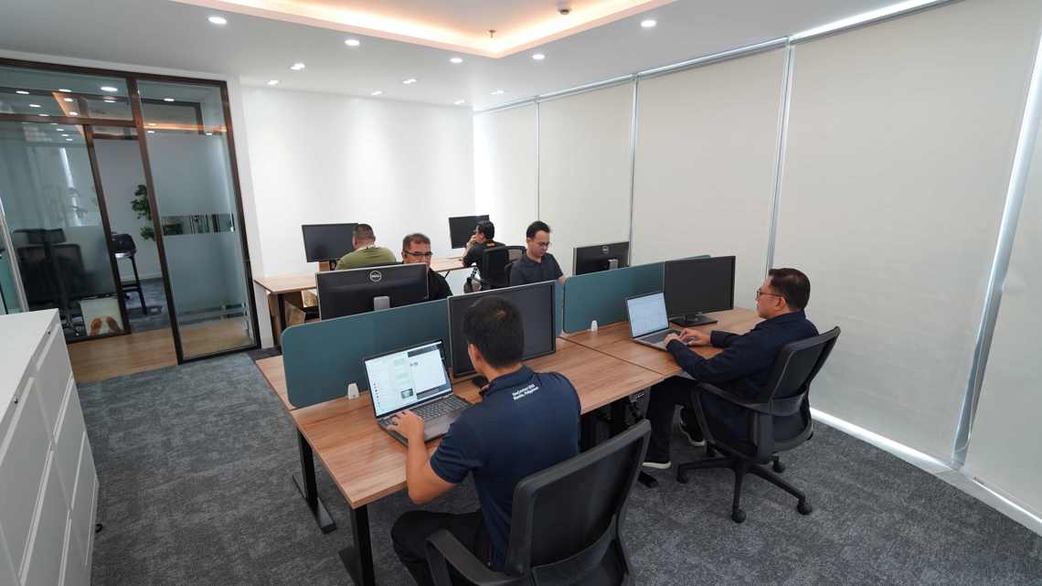 Employees working at computers in the new Kongsberg Maritime office in Manila.