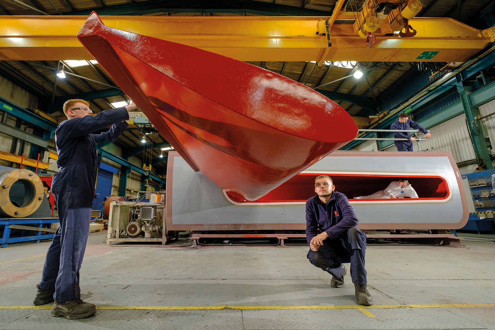 Two workers checking a Kongsberg Maritime stabilisor at the production siten.