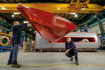 Two workers checking a Kongsberg Maritime stabilisor at the production siten.