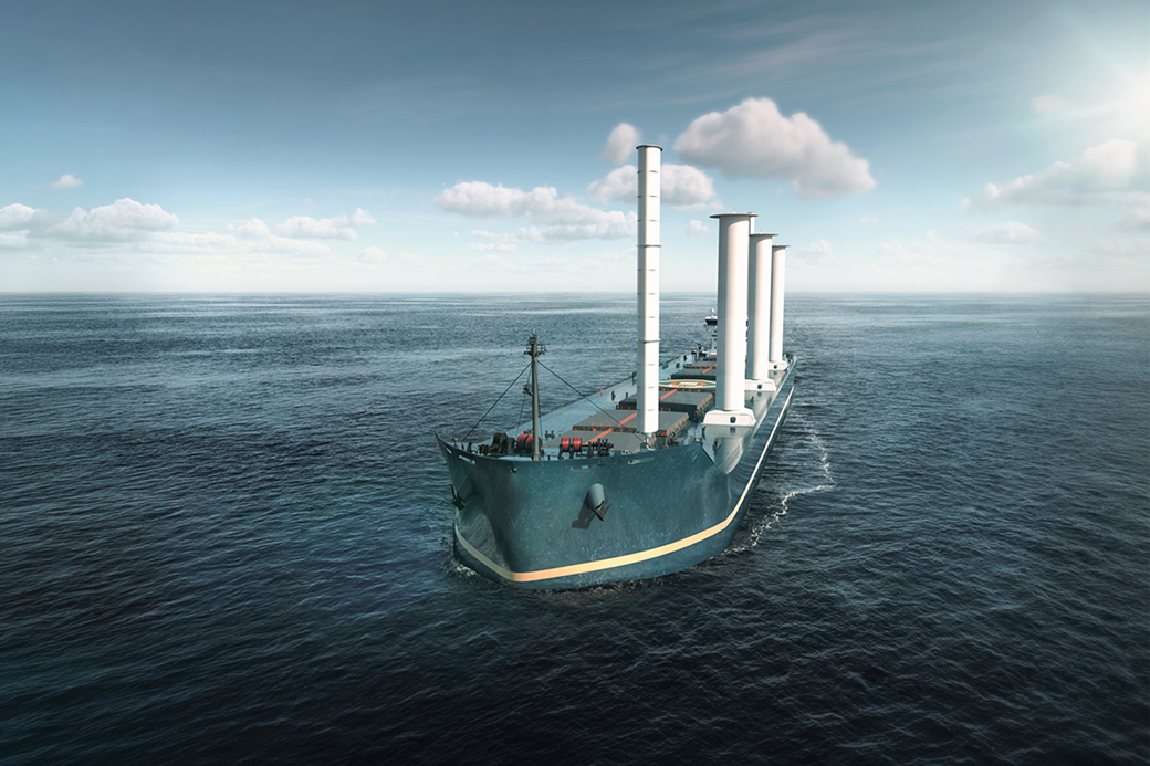 Cargo vessel equipped with wind-assisted propulsion sails across open water as part of a maritime decarbonisation concept