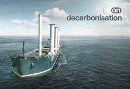Cargo vessel equipped with wind-assisted propulsion sails across open water