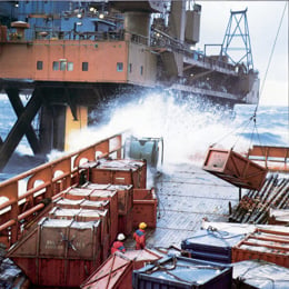 Supply ship working by offshore platform